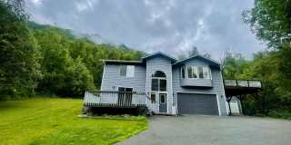 Fantastic 4 bedroom/3 bath/2 car garage home in prime secluded Chugiak location, additional carport, storage sheds and a big wrap around trex deck!! Gallery 1
