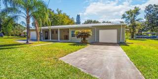 Charming 2BR/2BA Waterfront Home for Rent with Canal Access & Two Garages Gallery 1