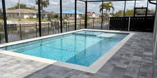 Brand-New Waterfront Luxury in Cape Coral | Heated Pool, Spa, Outdoor Kitchen & 3-Car Garage Gallery 32
