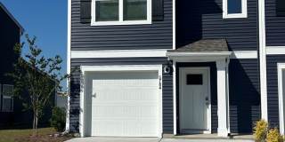 Welcome to this brand new end unit townhome that combines modern convenience with style and charm in Leland! Gallery 1