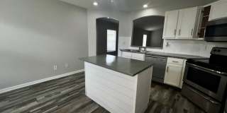 RESERVE AT WEDGEFIELD 3 bedroom 2 bath home with stainless appliances, laminate flooring and a fenced back  yard! Gallery 6