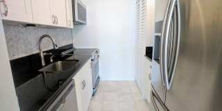 Sweeping Views from this partially furnished 1 Bed 1 Bath Condo w/ 1 Covered Parking Gallery 6