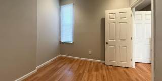 Charming 4BR/2BA Rowhouse with Hardwood-Style Flooring Throughout Gallery 4