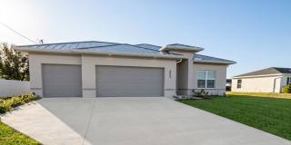 Brand-New Corner Lot Home with 3-Car Garage & Fenced Yard | Luxury Living in Cape Coral! Brand-New Corner Lot Home with 3-Car Garage & Fenced Yard | Luxury Living in Cape Coral! Gallery 1