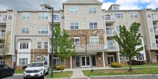 Beautiful 2nd floor (with elevator services) condominium: 2-bed, 2-bath, beautiful kitchen, bonus room, laundry room & deck! Gallery 1