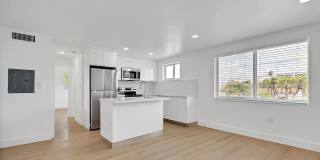 1 Bd/1 Ba corner unit with quartz countertops, washer/dryer, stainless steel appliances, 1 parking space. Gallery 1