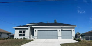 Brand-New Canal Front Home with Private Dock, 3-Car Garage & Modern Upgrades in Cape Coral Brand-New Canal Front Home with Private Dock, 3-Car Garage & Modern Upgrades in Cape Coral Gallery 1