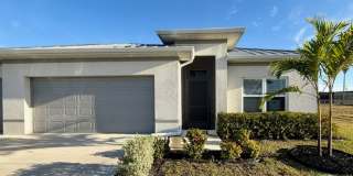 Modern 4-Bedroom Home with 3-Car Garage  Fenced Yard | New Construction in Prime Cape Coral Location! Gallery 1