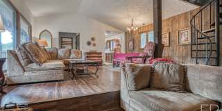 On the Blue River!  HUGE 4 Bedroom home, Furnished Updates throughout!  Bus route!  Spacious parking Gallery 1