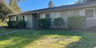 Welcome to This Charming 3 Bedroom Two Bath with a large fenced back yard Gallery 1