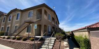 BEAUTIFUL CONDO IN A GATED COMMUNITY FEATURING PLANTATION SHUTTERS, TILE FLOORING AND NEW PAINT THROUGHOUT! Gallery 1