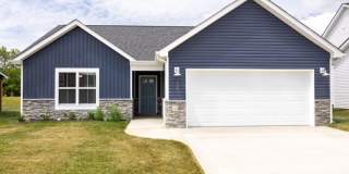 Modern Living Redefined with Stone Fireplace, Gray Cabinetry, Spa Inspired Primary Suite and Covered Outdoor Retreat Gallery 1