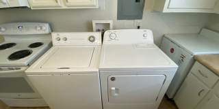 Private carport, in-unit laundry, and the Lakewood strip right outside your door. Gallery 7