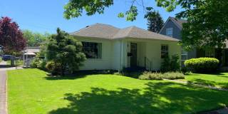 Model three bedroom home, with well-maintained yard  attached garage! Gallery 1