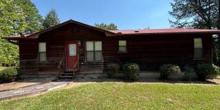 Located on the outskirts of Russellville, this three-bedroom, two-bath home Gallery 1