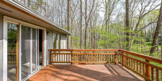 Welcome home! One of a kind, strikingly designed 2-level hillside chalet built on 1 1/2 acres of wooded property with stream surrounded by park land. Gallery 12
