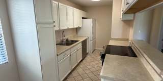2BR/1BA Lakeside ground floor condo with 1 car detached garage, 1 uncovered parking space & community pool. Gallery 6