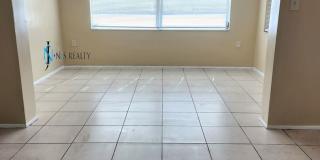 Beautiful 2/2/1 1150 Sq. Ft. with BONUS ROOM!!... tile & luxury plank flooring, Frest paint and a large fenced in yard! Gallery 8