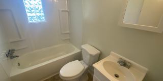 Private carport, in-unit laundry, and the Lakewood strip right outside your door. Gallery 8