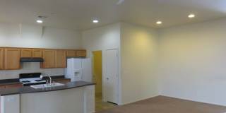 Huge family room with kitchen nicely tucked in the middle. Gallery 12