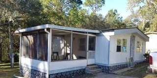 Freshly painted spacious 2-bedroom 1-bath home with a screened porch and storage shed. Gallery 1