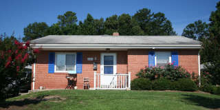 Two bedrooms, hardwood throughout, and a private driveway — all under $1,400 near Duke West. Gallery 1