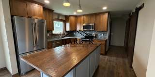 *1/2 Off First Months Rent* Spacious 3BR Home with 2-Stall Garage & Private Deck in Kasson Gallery 1