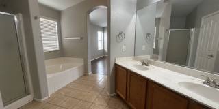 Single-level 3-bedroom home in a desirable Chandler location featuring a 2-car garage and tile roof and wood plank flooring throughout Gallery 24