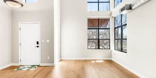 Modern 2BD, 1.5BA Condo with 20' Ceilings and Garage Parking Spot Gallery 1