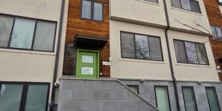 STUNNING 4-LEVEL TOWNHOME IN HIGHLANDS WITH SAUNA, 2-CAR GARAGE + AMAZING ROOFTOP DECK! Gallery 1