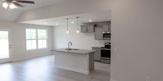 Modern Living Redefined with Stone Fireplace, Gray Cabinetry, Spa Inspired Primary Suite and Covered Outdoor Retreat Gallery 5