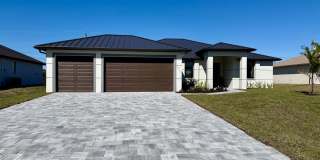 Luxury Waterfront Paradise with Heated Pool, Spa & 3-Car Garage | Brand-New 2026 Cape Coral Home Gallery 1