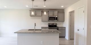 Modern Living Redefined with Stone Fireplace, Gray Cabinetry, Spa Inspired Primary Suite and Covered Outdoor Retreat Gallery 7