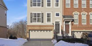 This bright end unit offers a two car garage and a premium setting backing to a peaceful treed common area. Gallery 1