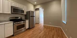Charming 4BR/2BA Rowhouse with Hardwood-Style Flooring Throughout Gallery 8