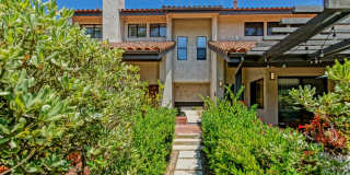 PRIME POOLFRONT LOCATION & CLOSE TO MAIN GATE! BRIGHT & SPACIOUS, END-UNIT POOLFRONT TOWNHOUSE W/ SPACIOUS & PRIVATE PATIO OVERLOOKING POOL, 2 BALCONIES & BRIGHT LIVING SPACE IN PRESTIGOUS, GATED MANHATTAN VILLAGE! Gallery 1