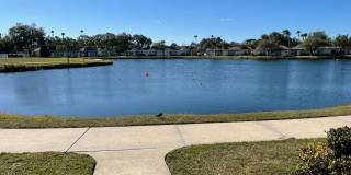 1/1 Furnished with Lake View & Utilities in Tahitian Gardens a 55+ Community. Gallery 1