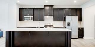 Welcome to this beautifully designed 3 level townhome in Westphalia Town Center Community! Gallery 3