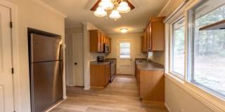 Larger House, Smaller Price.  Year Lease.  Garage! Extra Fridge! 4th bedroom or extra living! Cabin in the woods!  Blue River! New Floors! Gallery 1