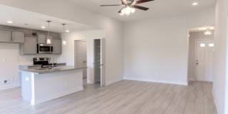 Modern Living Redefined with Stone Fireplace, Gray Cabinetry, Spa Inspired Primary Suite and Covered Outdoor Retreat Gallery 11