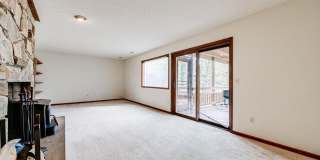 Welcome home! One of a kind, strikingly designed 2-level hillside chalet built on 1 1/2 acres of wooded property with stream surrounded by park land. Gallery 23