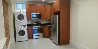 Nicely updated ground level 1 bed with in-unit laundry near the Green Line. Gallery 1