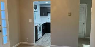 This residence showcases a beautifully updated kitchen with a sleek modern-contemporary aesthetic. Gallery 7