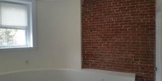 Nicely updated ground level 1 bed with in-unit laundry near the Green Line. Gallery 3