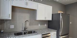 Large main floor duplex unit, Updated Kitchen & Bath, Full Dining Room w/Built-ins + Sunroom, garage stall Gallery 12