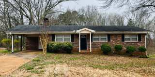 Charming 3-bedroom, 1.5-bath brick ranch situated on a large private lot in Carrollton! Must see! Gallery 1