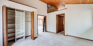 Welcome home! One of a kind, strikingly designed 2-level hillside chalet built on 1 1/2 acres of wooded property with stream surrounded by park land. Gallery 18