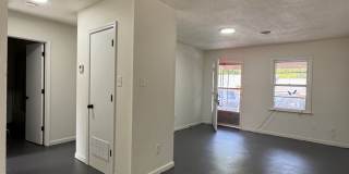 This freshly repainted and refreshed single-story brick duplex- End Unit Gallery 1