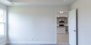 Modern Living Redefined with Stone Fireplace, Gray Cabinetry, Spa Inspired Primary Suite and Covered Outdoor Retreat Gallery 16