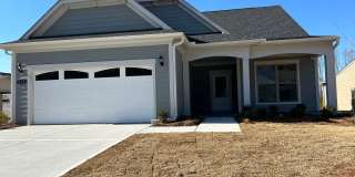 **Ask how you can move into this property with NO SECURITY DEPOSIT!** 505 Colebrook Way: Newer Construction (2023), 4BD, 3BA Ranch Home For Rent in Everton Village in PTC! Close to HWY 54  74, Shopping, and Restaurants. MUST SEE! Available NOW! Gallery 1